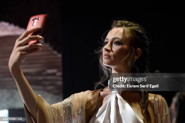 In this image released on October 15, A model takes a selfie backstage ahead of the Simay Bülbül show during Mercedes-Benz Istanbul Fashion Week at...