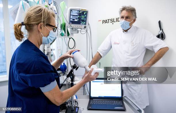 Research nurse Simone Mulder and lung specialist Hans in't Veen present a bladder test to detect the novel coronavirus Covid-19 in the emergency...