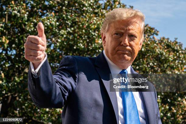 President Donald Trump gives a thumbs up to members of the media before boarding Marine One on the South Lawn of the White House in Washington, D.C.,...