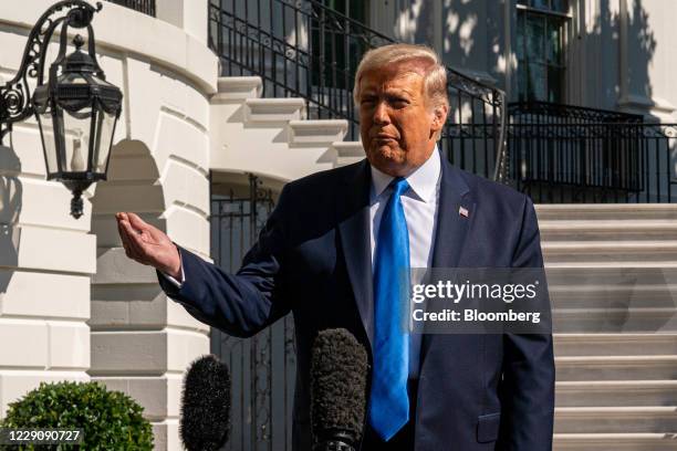 President Donald Trump speaks to members of the media before boarding Marine One on the South Lawn of the White House in Washington, D.C., U.S., on...