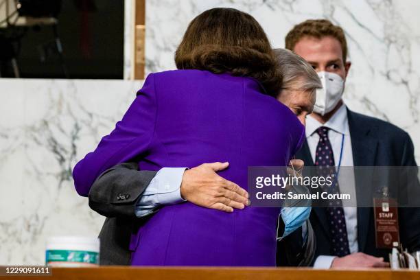 Ranking Member Dianne Feinstein and Chairman Lindsey Graham hug as the confirmation hearings for Supreme Court nominee Judge Amy Coney Barrett come...