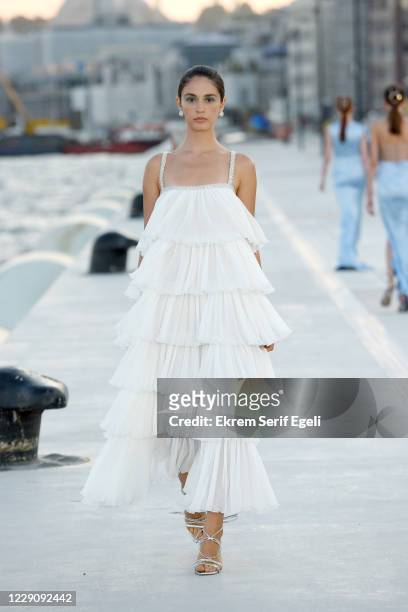 In this image released on October 15, A model walks the runway during the Özgür Masur show during Mercedes-Benz Istanbul Fashion Week at Galataport...