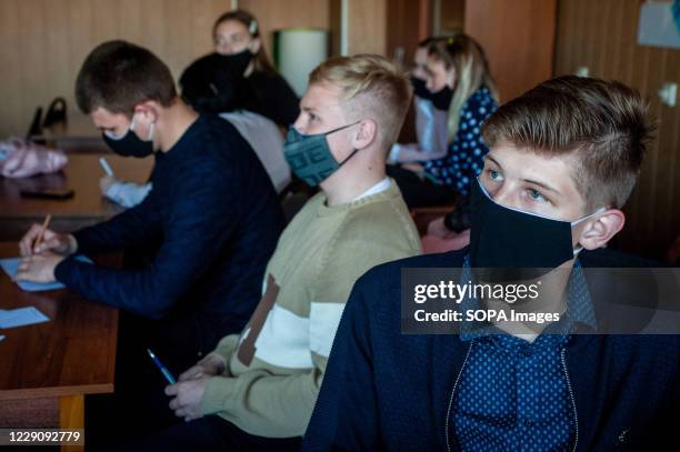 Students wearing face masks as a preventive measure attend an intellectual game at the Tambov leisure center. High school students from various...