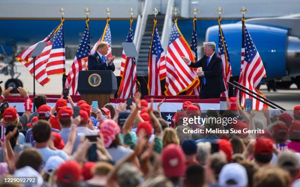 President Donald Trump and White House Chief of Staff Mark Meadows appear on stage during a Make America Great Again rally at the Pitt-Greenville...