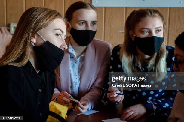 Students wearing face masks as a preventive measure attend an intellectual game at the Tambov leisure center. High school students from various...