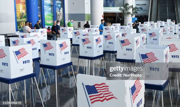 Election workers set up voting booths at an early voting site established by the City of Orlando and the Orlando Magic at the Amway Center, the home...