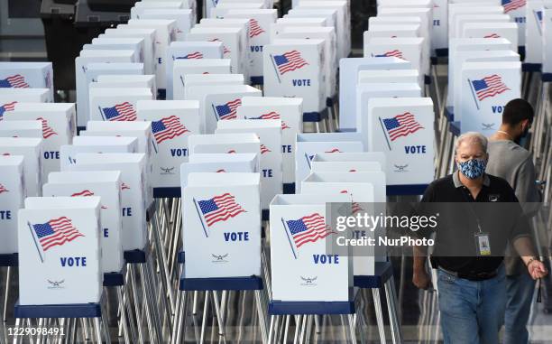 Election workers set up voting booths at an early voting site established by the City of Orlando and the Orlando Magic at the Amway Center, the home...