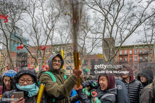 Confetti cannon blasts over the crowd at the 17th Chinese New Year Firecracker Ceremony & Cultural Festival .