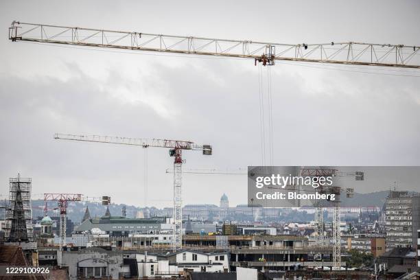Cranes tower over under-construction residential sites in Budapest, Hungary, on Wedsday, Oct. 14, 2020. Hungary will cut the value-added tax on...