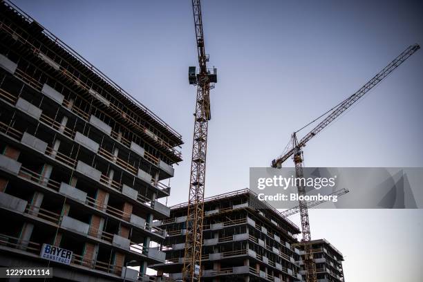 Cranes tower over under-construction residential apartments in Budapest, Hungary, on Wedsday, Oct. 14, 2020. Hungary will cut the value-added tax on...