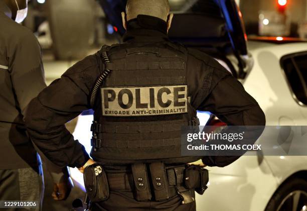 French police officer of the anti-crime squad, Brigade Anti-Criminalite de nuit is seen during a night patrol in Paris on October 16, 2020.