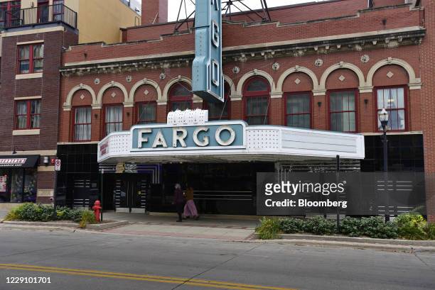 Pedestrians pass in front of the Fargo Theatre temporary closed due to the Coronavirus in downtown Fargo, North Dakota, U.S., on Thursday, Oct. 15,...