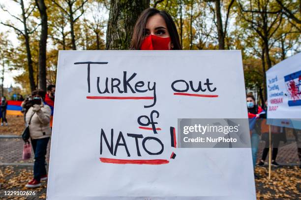 An Armenian woman is holding a big placard against Turkey, during the Armenian community protest against Israel's arms deliveries to Azerbaijan, in...