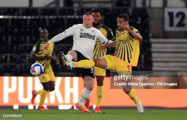 Derby County's Wayne Rooney and Watford's William Troost-Ekong battle for the ball during the Sky Bet Championship match at Pride Park, Derby.