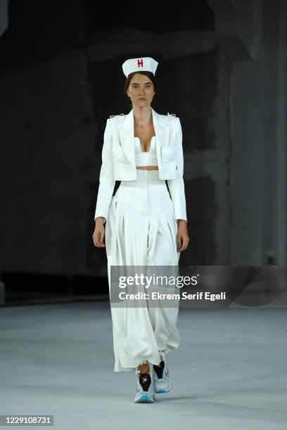 In this image released on October 16, A model walks the runway during the Hakan Yldrm show during Mercedes-Benz Istanbul Fashion Week at Galataport...