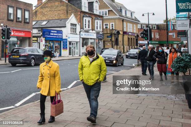 Shoppers wear face coverings to help prevent the spread of the coronavirus on 16 October 2020 in Weybridge, United Kingdom. The Government has...