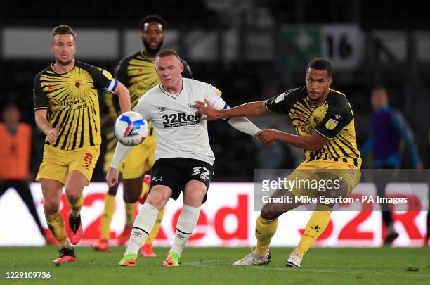 Derby County's Wayne Rooney and Watford's William Troost-Ekong battle for the ball during the Sky Bet Championship match at Pride Park, Derby.
