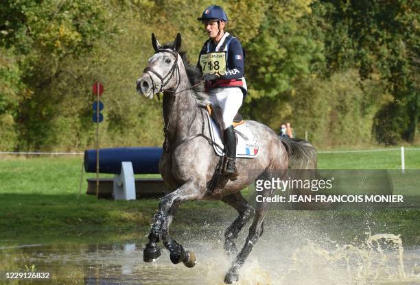 Second-placed of the 7 years-old horse category, France's Nicolas Touzaint, rides Diabolo Menthe during the Cross Country event "Mondial du...