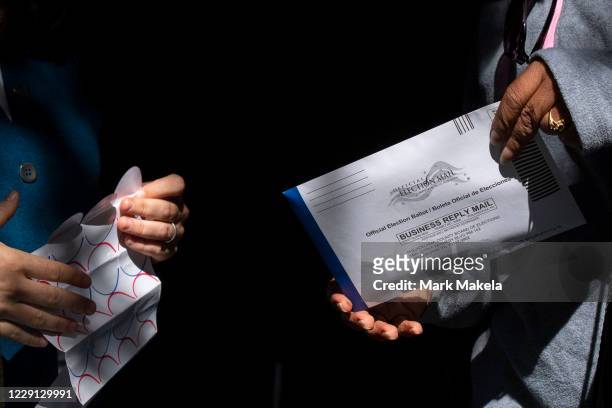 Voter casts her early voting ballot at the A. B. Day School polling location on October 17, 2020 in Philadelphia, Pennsylvania. With the election...
