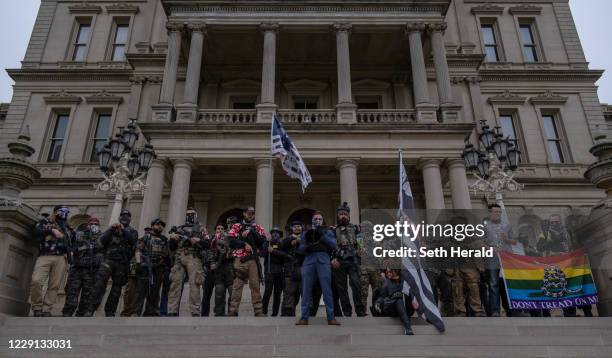 The Boogaloo Boys stand on the steps of the Capitol Building during a rally on October 17, 2020 in Lansing, Michigan. The Boogaloo boys called it a...