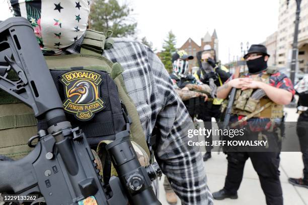 Group tied to the Boogaloo Bois holds a rally as they carry firearms at the Michigan State Capitol in Lansing, Michigan on October 17, 2020.