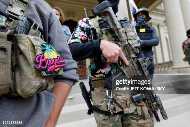 Group tied to the Boogaloo Bois holds a rally as they carry firearms at the Michigan State Capitol in Lansing, Michigan on October 17, 2020.