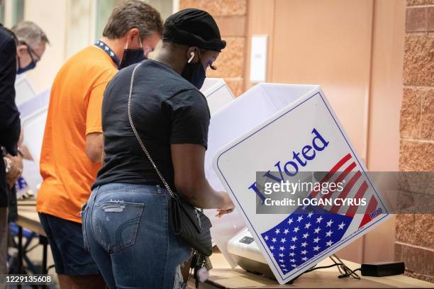 Voters cast their ballots in the voting booths at the early vote location at the Charleston Coliseum and Convention Center in North Charleston, South...