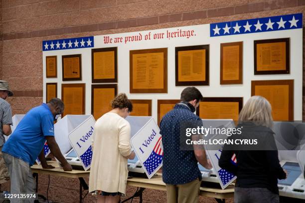 Voters cast their ballots in the voting booths at the early vote location at the Charleston Coliseum and Convention Center in North Charleston, South...