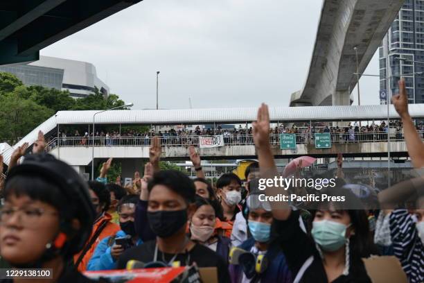 Student protesters hold up three-finger salutes as a symbol of defiance against the government. Students from many places and pro-democracy...