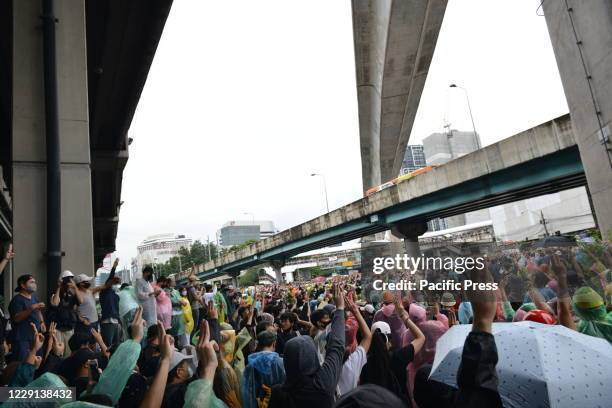 Student protesters hold up three-finger salutes as a symbol of defiance against the government. Students from many places and pro-democracy...