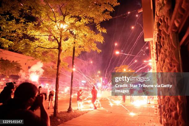 Minneapolis, MN May 27: Protesters lobbed fireworks, rocks and glass bottles at police near the Third Precinct."nProtester and police clashed...