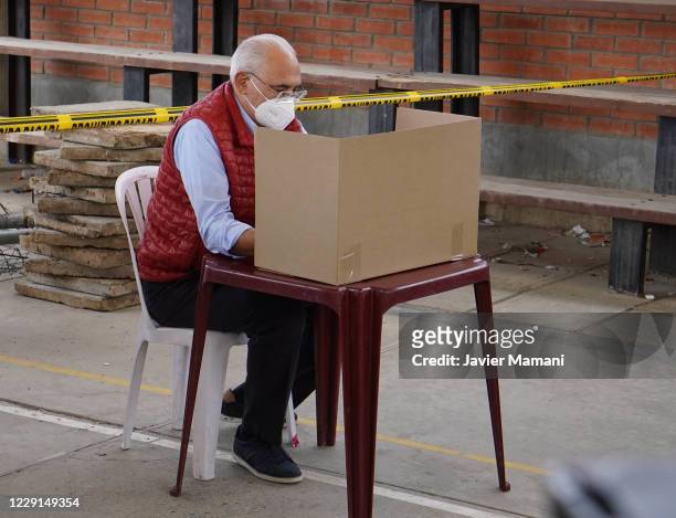 Carlos Mesa presidential candidate of Comunidad Ciudadana checks the ballot in Centro de Capacitacion Inti Phaxsi during general elections day on...