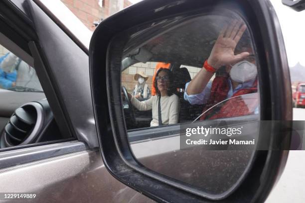 Carlos Mesa presidential candidate of Comunidad Ciudadana waves supporters from his car after voting in Centro de Capacitacion Inti Phaxsi during...