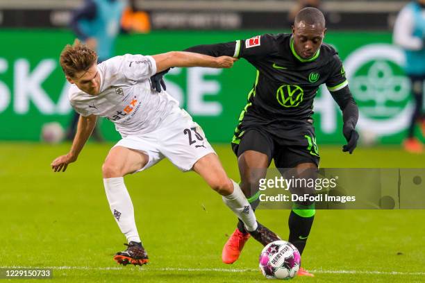 Jonas Hofmann of Borussia Moenchengladbach and Jerome Roussillon of VfL Wolfsburg battle for the ball during the Bundesliga match between Borussia...