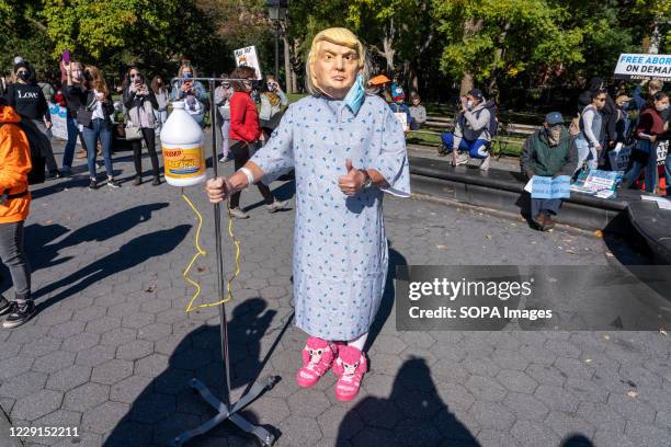 Protester dressed in a Trump costume at Washington Square Park during the demonstration. Thousands took to the streets across the US for women's...