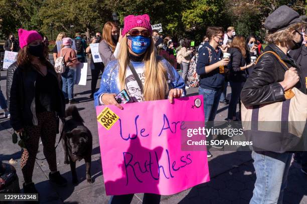 Protester holds a placard expressing her opinion at Washington Square Park during the demonstration. Thousands took to the streets across the US for...