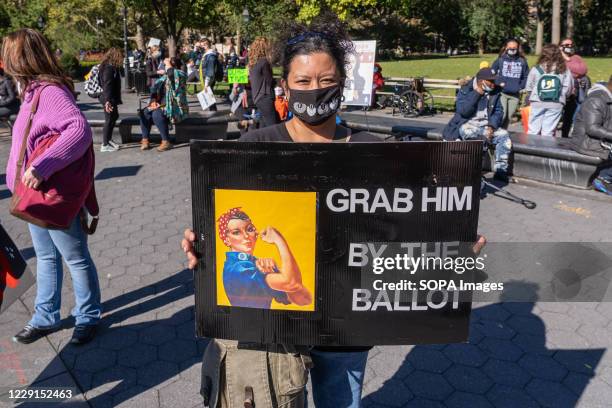 Protester holds a placard expressing her opinion at Washington Square Park during the demonstration. Thousands took to the streets across the US for...