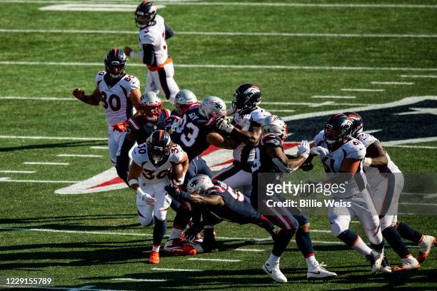 Phillip Lindsay of the Denver Broncos carries the ball during the second half of a game against the New England Patriots at Gillette Stadium on...