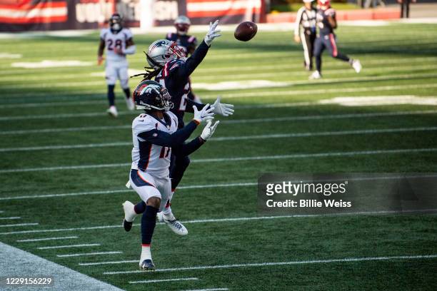 Stephon Gilmore of the New England Patriots breaks up a pass intended for DaeSean Hamilton of the Denver Broncos during the second half of a game at...
