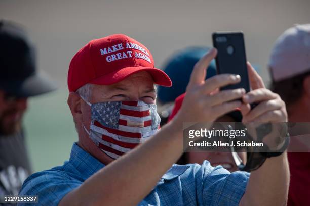 Supporters take photos as they anticipate President Donald Trumps arrival on Air Force One at John Wayne Airport on Sunday, Oct. 18, 2020 in Santa...
