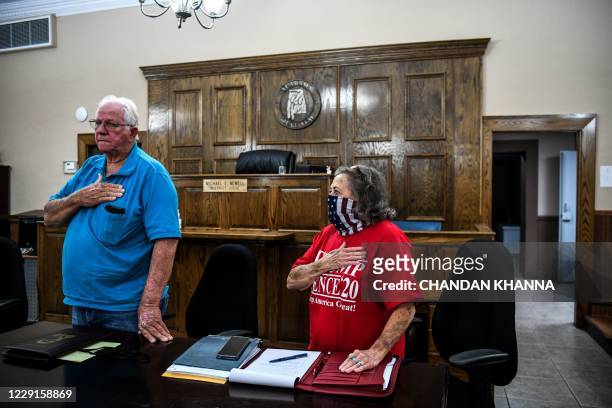 Chairman of local Republican party Jerry Mobley and Ronnie Mobley stand for national anthem, before a meeting of the local Republican party at...