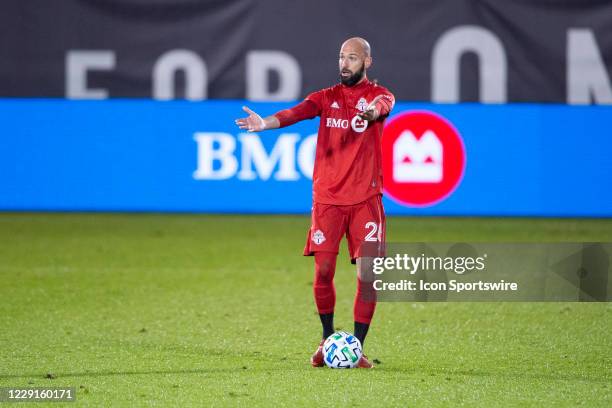 Toronto FC Defender Laurent Ciman controls the ball and motions to his teammates during the second half of a Major League Soccer match between the...