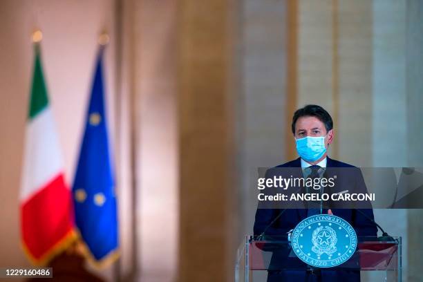 This photo taken on October 18 and provided by Italian news agency ANSA shows Italian Prime Minister Giuseppe Conte giving a press conference to...