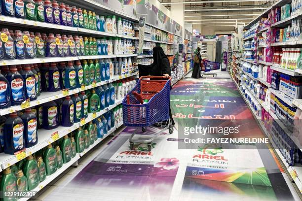 Woman shops for laundry detergent at a supermarket in Saudi Arabia's capital Riyadh on October 18, 2020. - Following a call by the head of the Saudi...