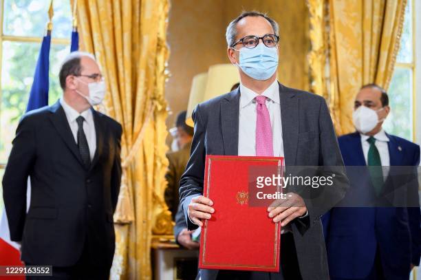 President and CEO of GE Renewable Energy Jerome Pecresse poses during a contracts and economic agreements signing ceremony at the Hotel de Matignon...