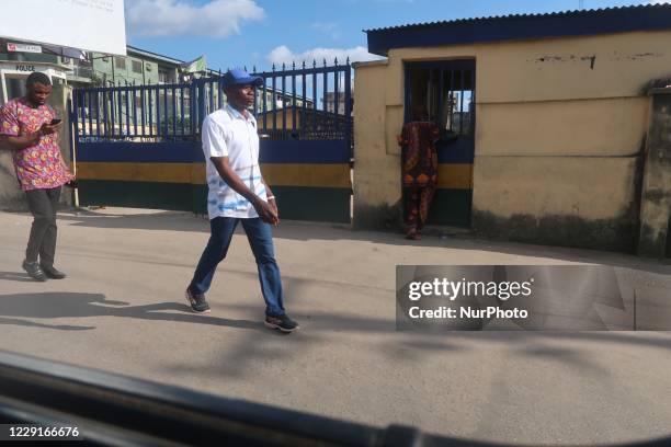 Two men walk past a police station in Ikeja as the youths continue their #ENDSARS protest in Lagos, Nigeria, on Sunday, October 18, 2020. The...