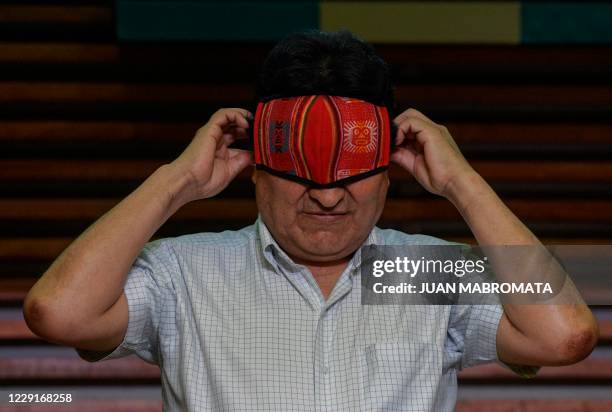 Bolivian ex-president Evo Morales puts his face mask on after offering a press conference in Buenos Aires on October 19, 2020 a day after Bolivia...
