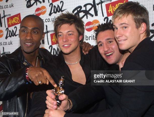 British boy band 'Blue' Simon Webb, Duncan James, Antony Costa and Lee Ryan, pose for the media with the Best Newcomer award of the 2002 Brit Awards,...