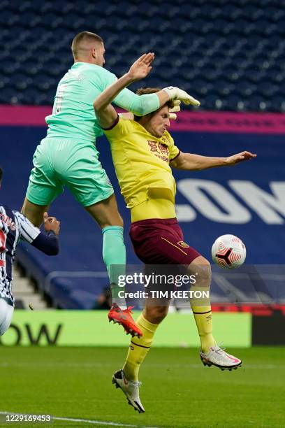 West Bromwich Albion's English goalkeeper Sam Johnston drops the ball under pressure from Burnley's New Zealand striker Chris Wood during the English...