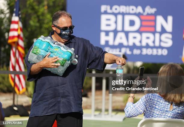 Stan Van Gundy hands out water to guests before a Women for Biden event at Van Gundys home in Lake Mary on Friday,October 16, 2020.